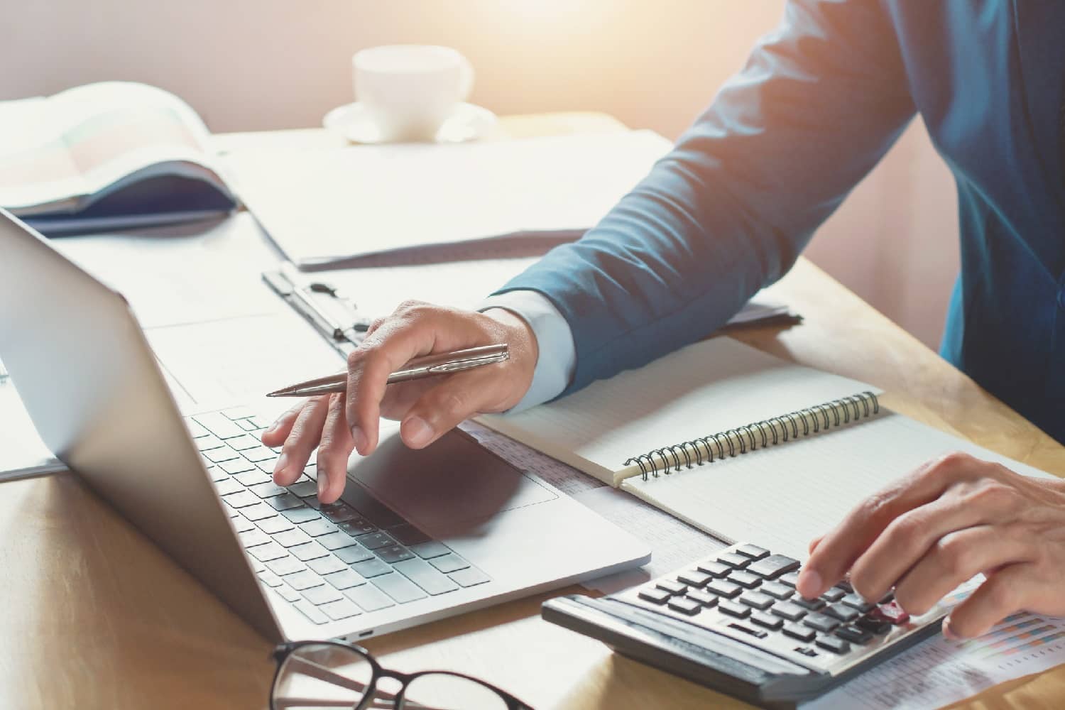 Businessman with a calculator and laptop