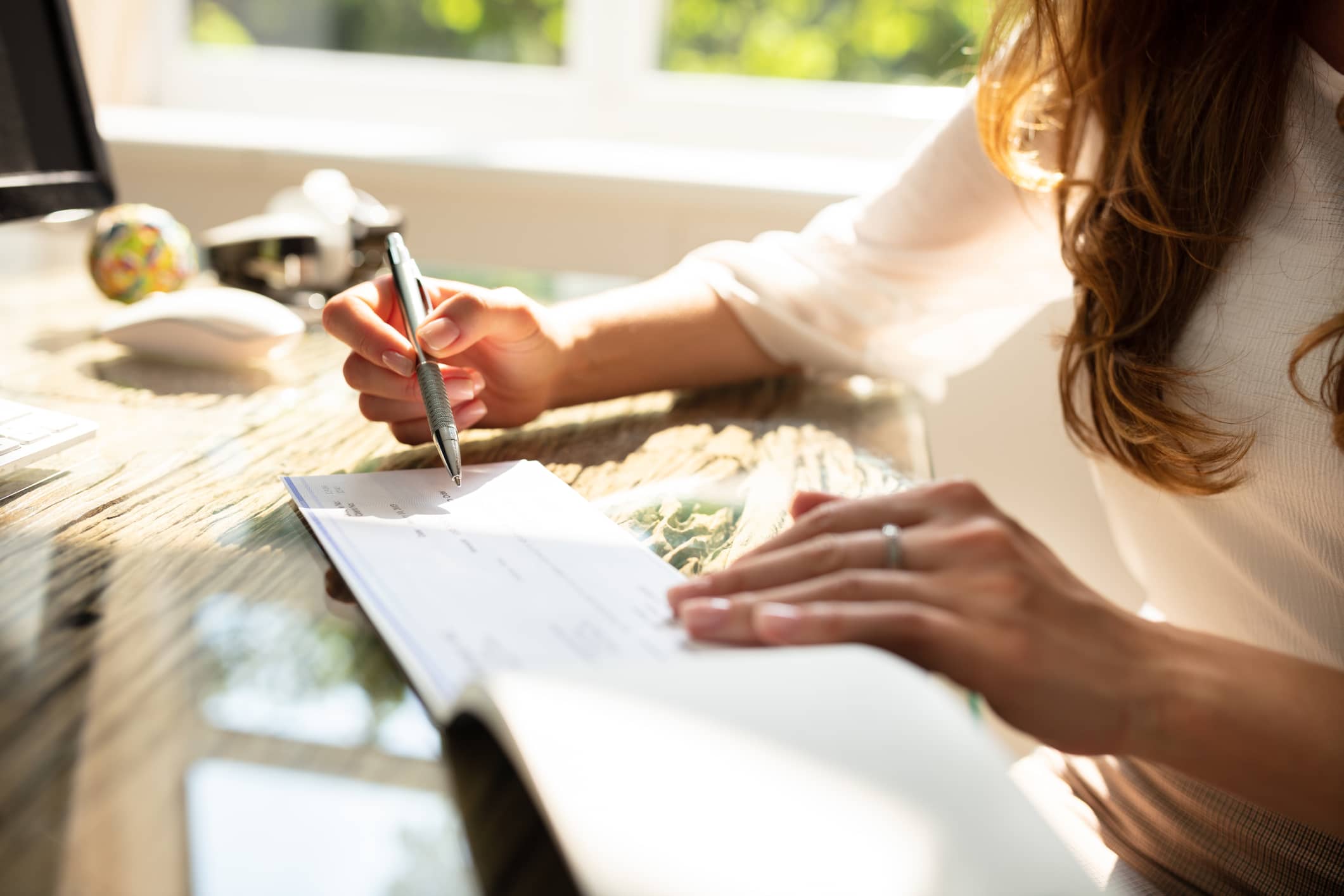 Businesswoman signing a paycheck