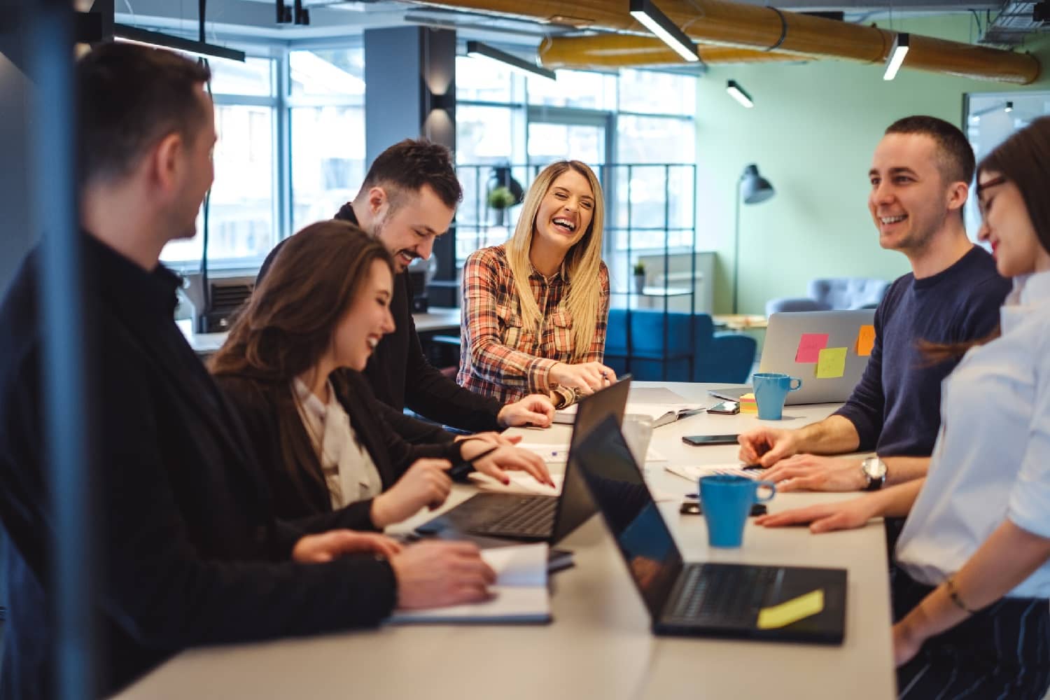 Happy colleagues laughing