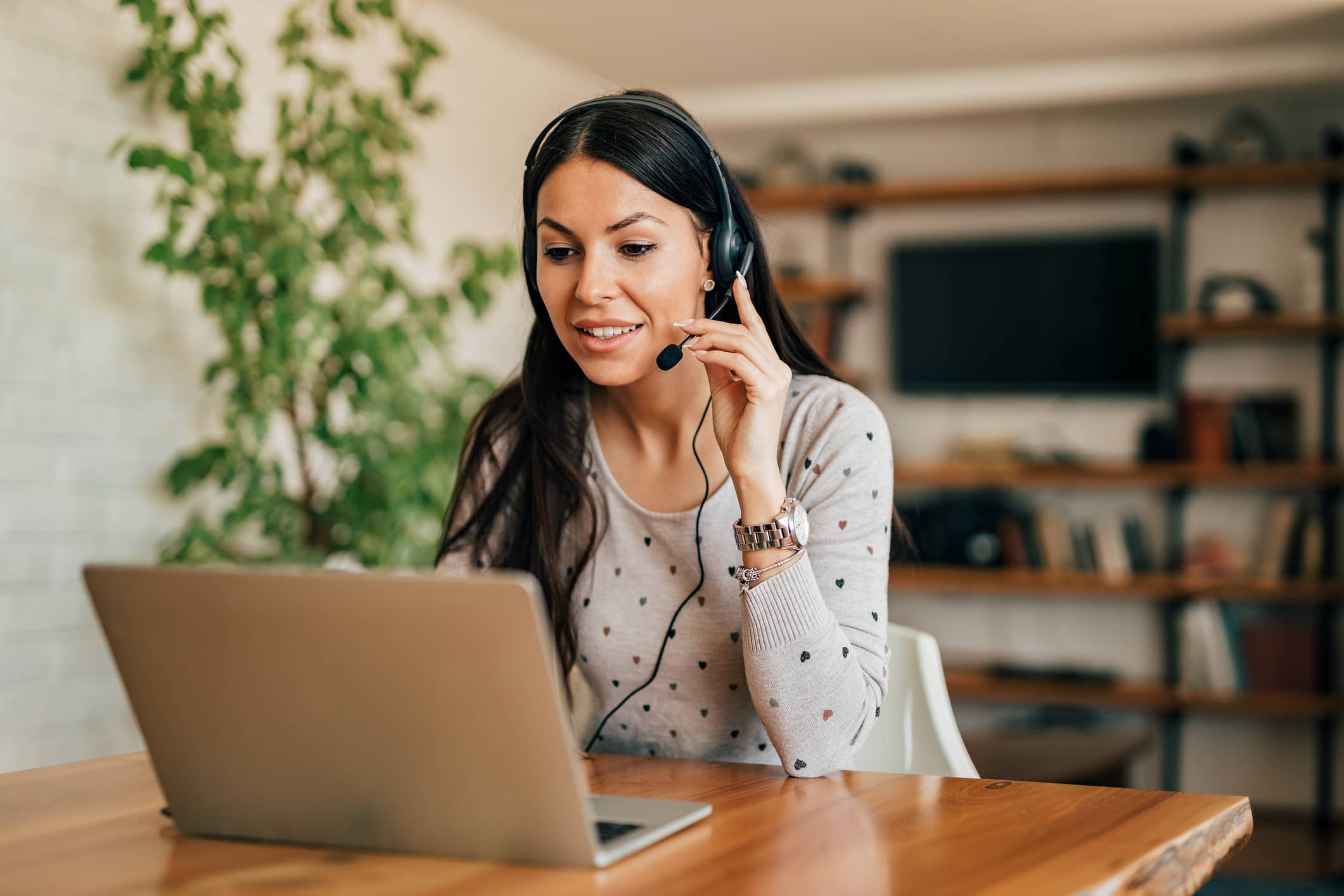 woman at a laptop with a headset on