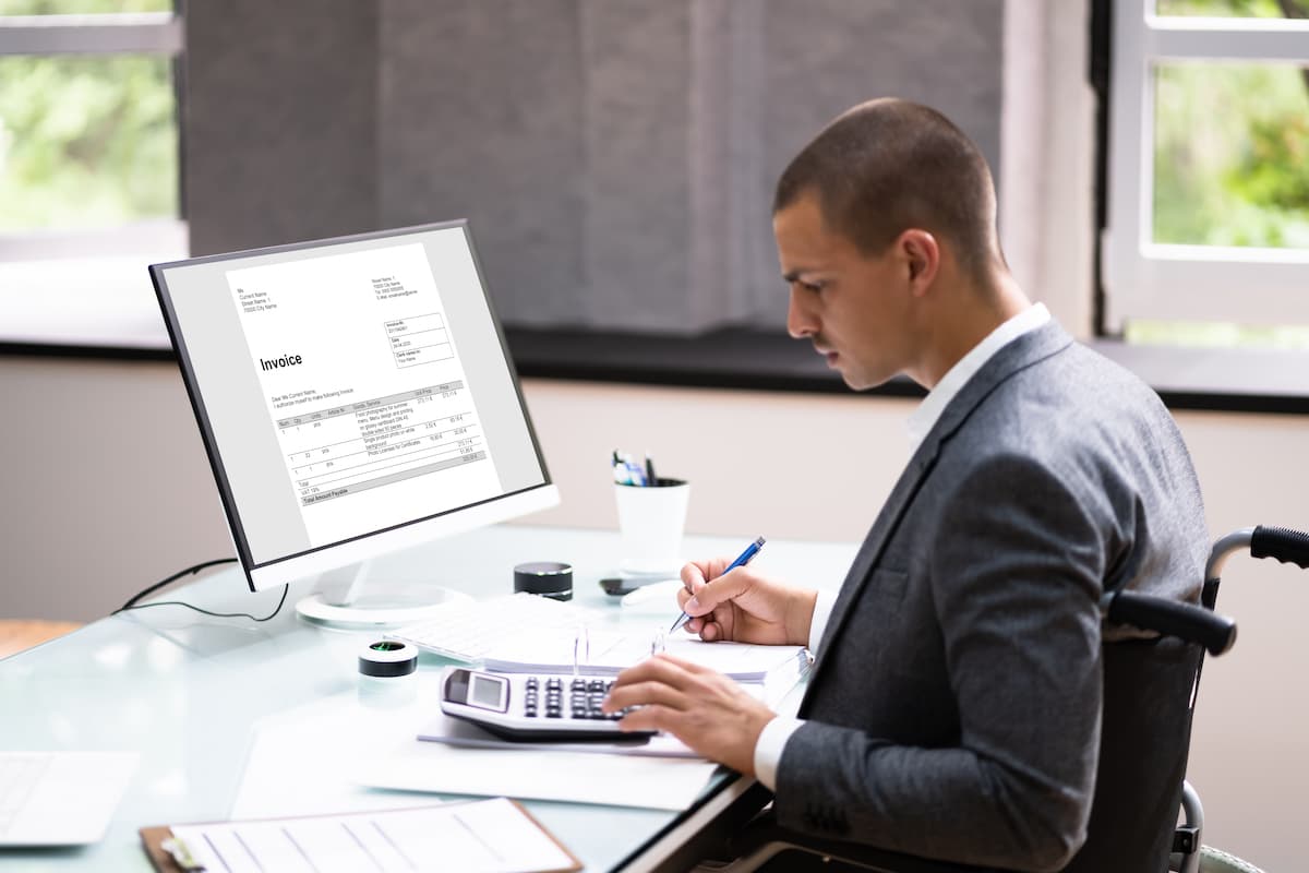 Accountant in a wheelchair working at a desk