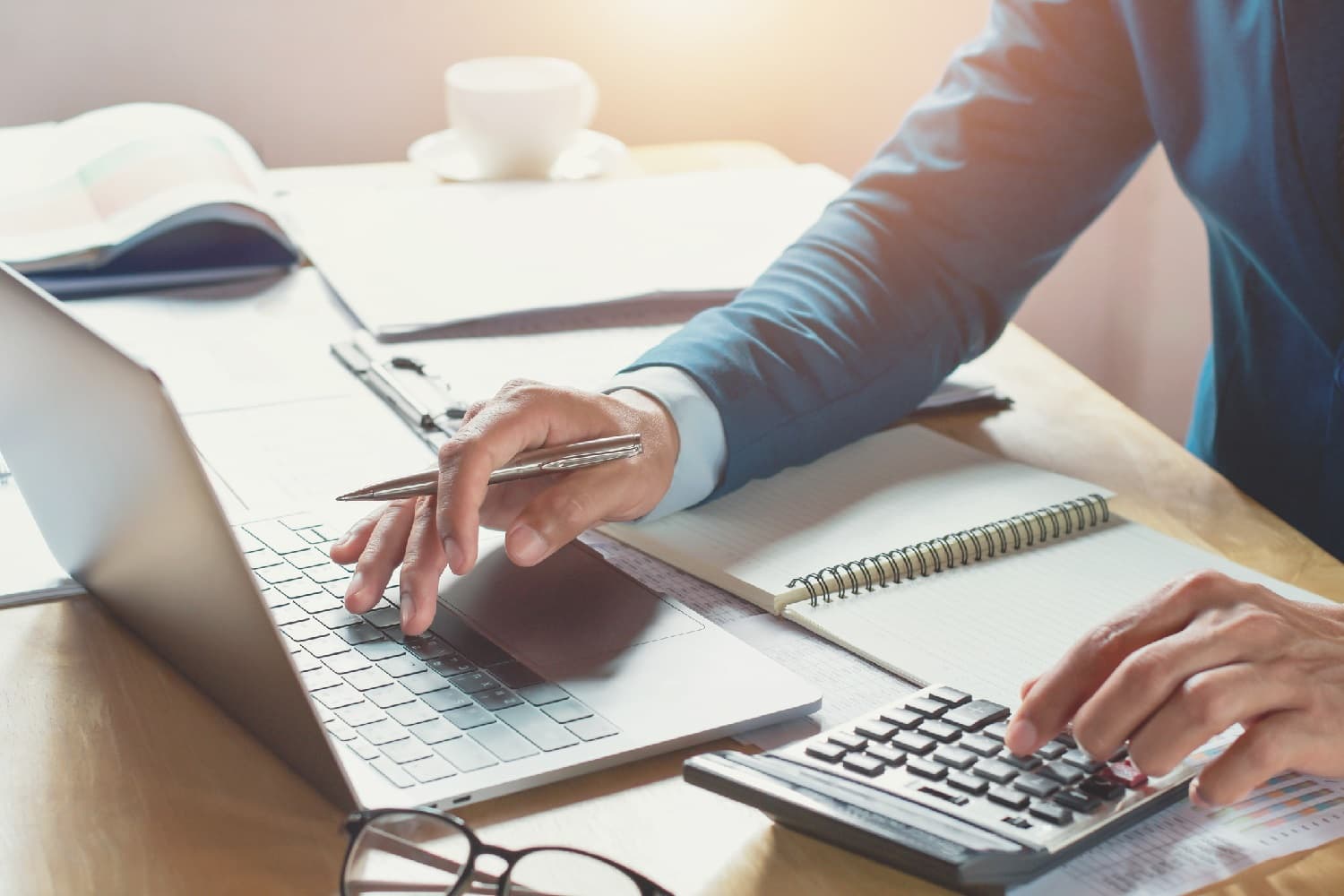 Businessman with a calculator and laptop