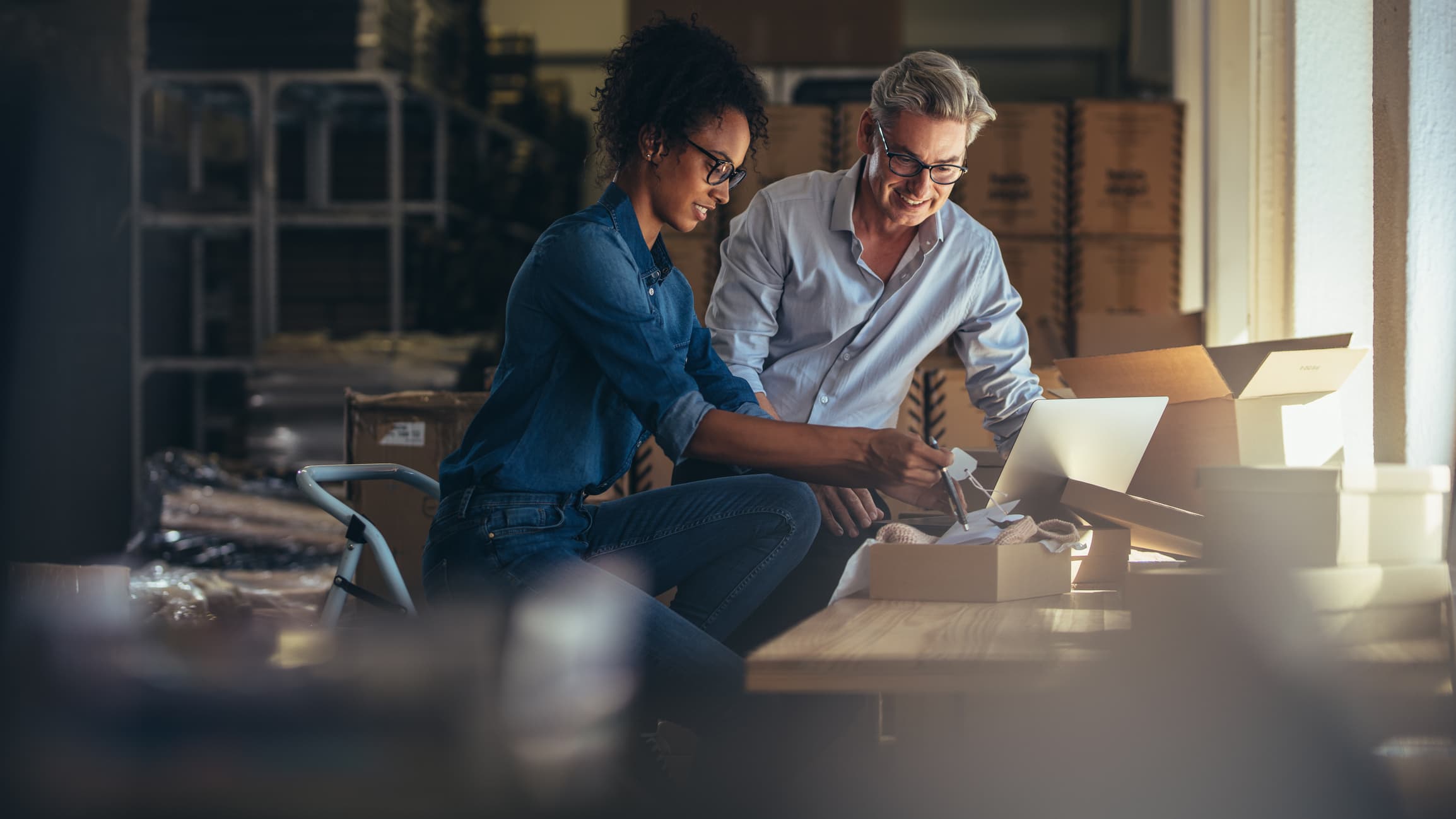 Two business owners packing goods for a delivery