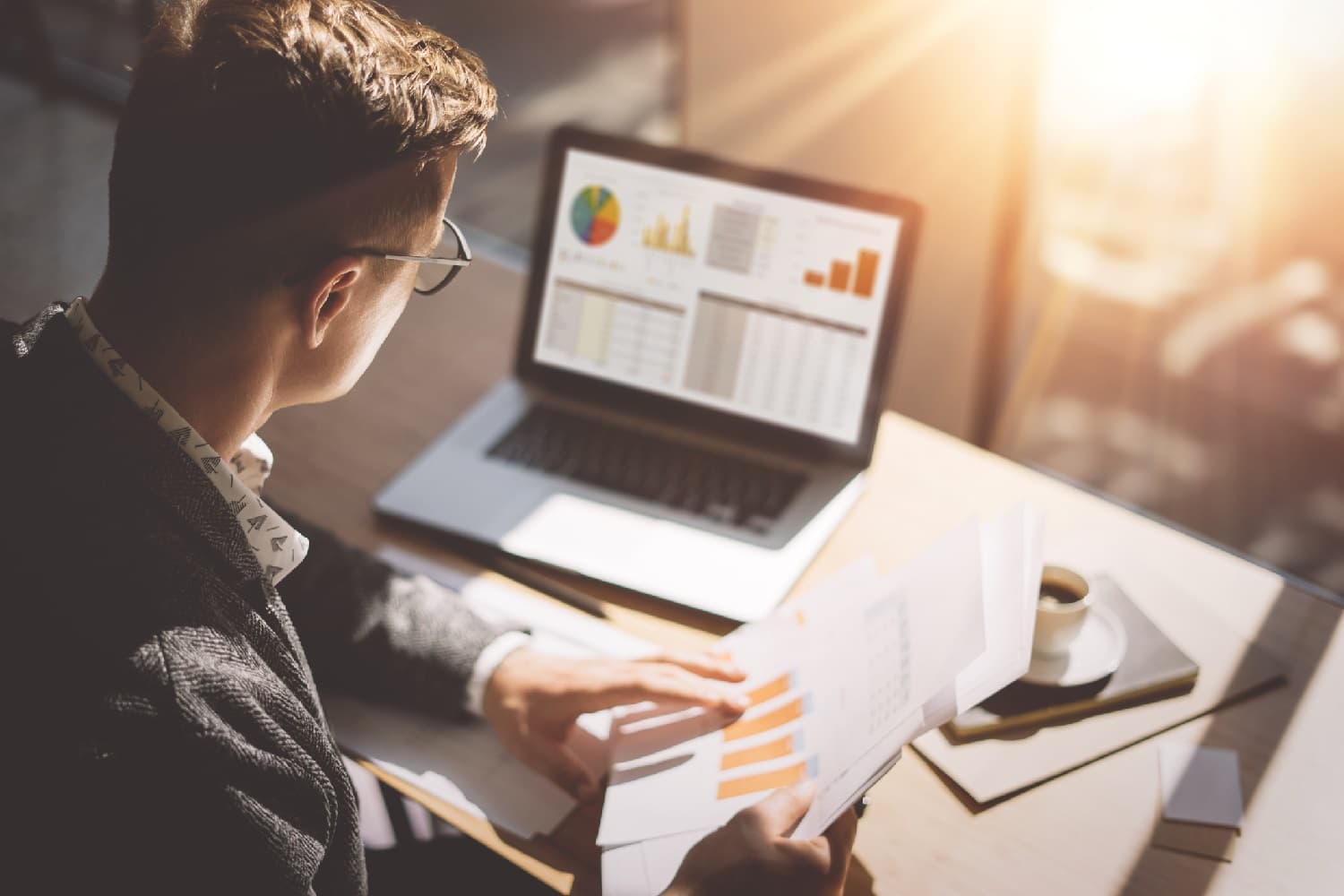 man looking at data on a laptop