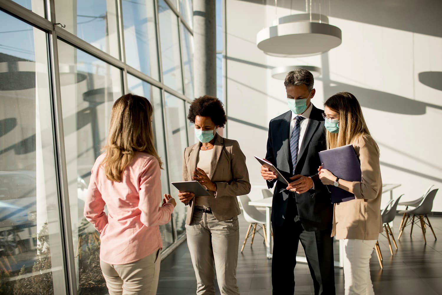 group of people in an office wearing masks