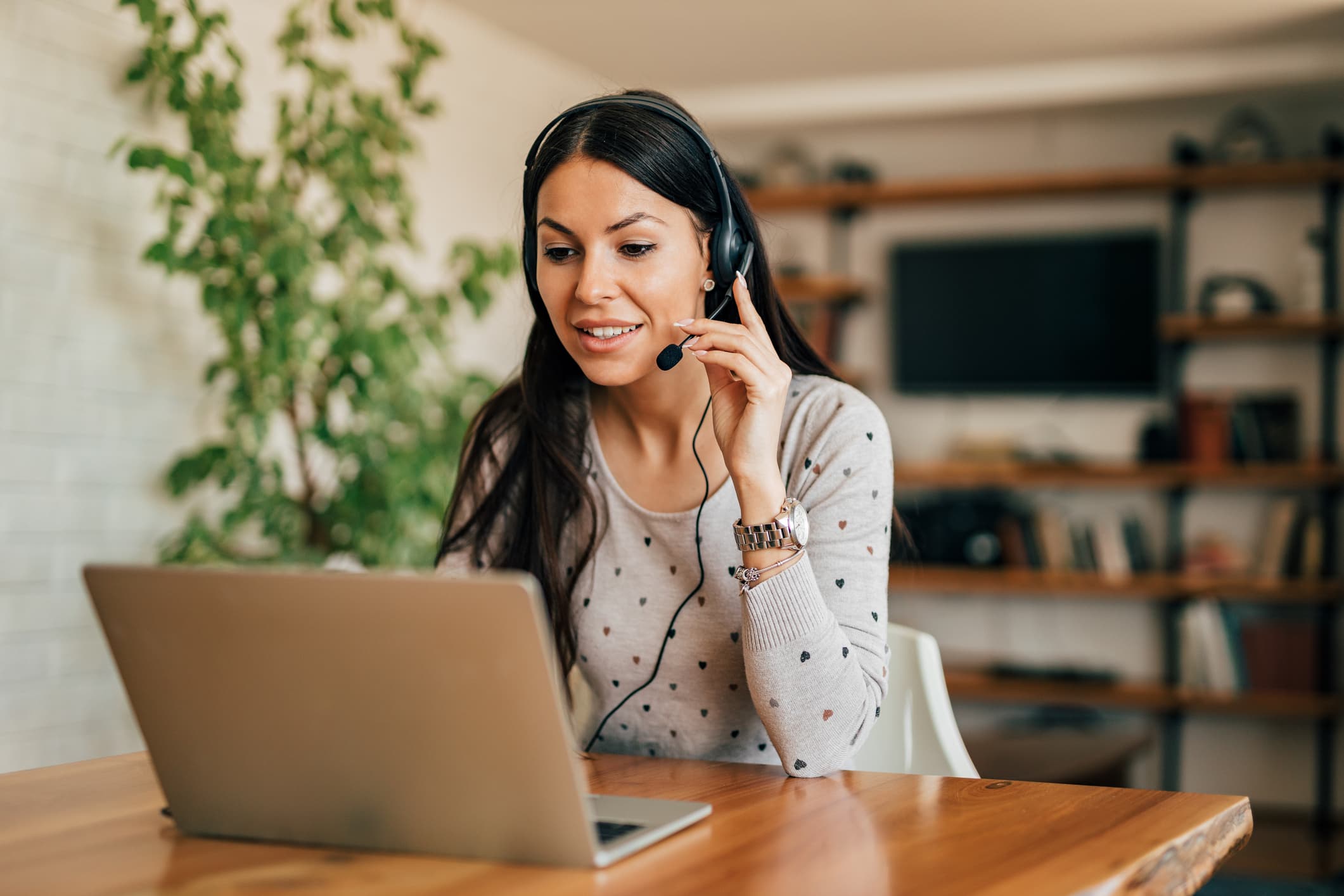 woman at a laptop with a headset on