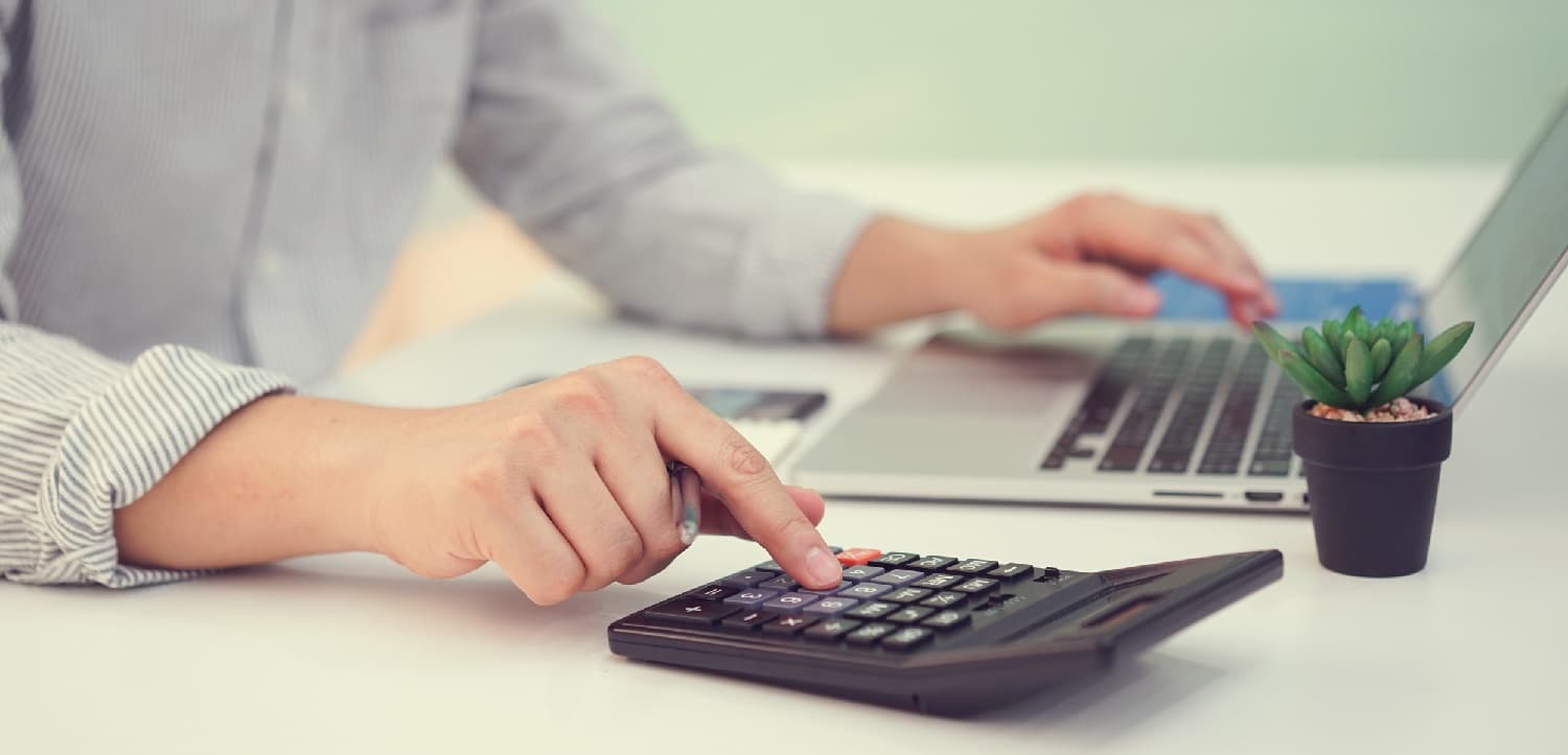 accountant using a laptop and a calculator