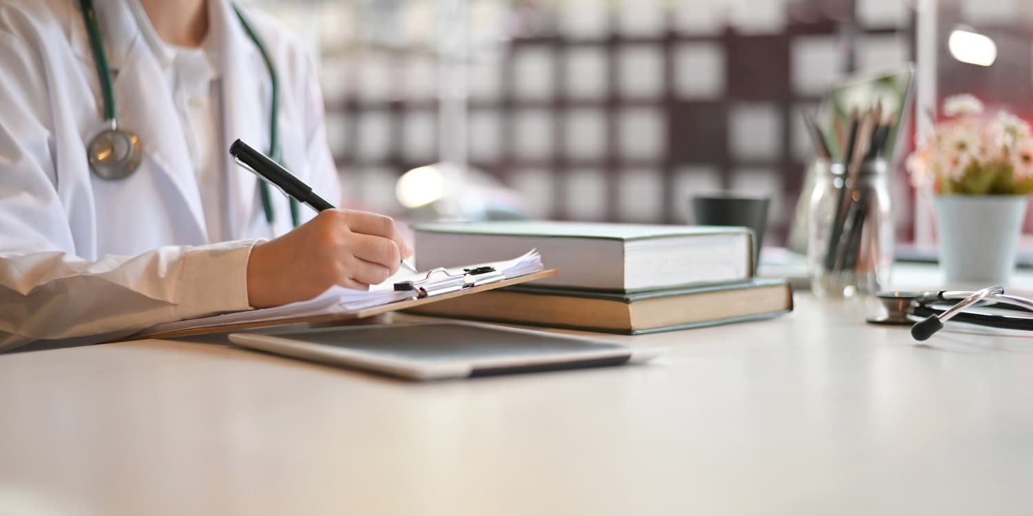 Doctor signing a form