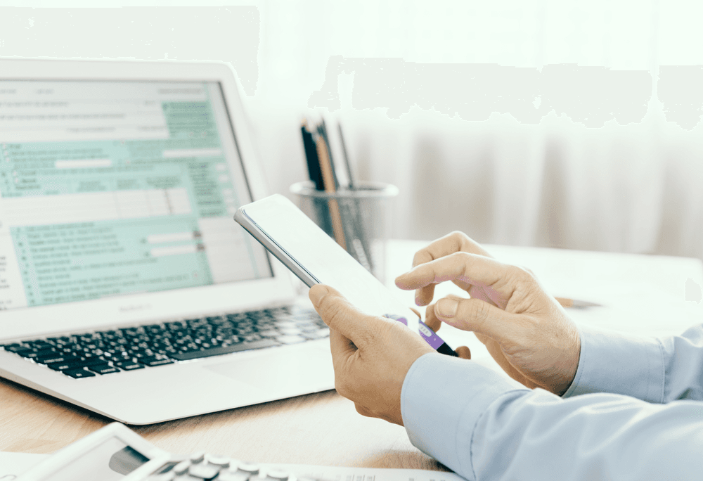 accountant holding a phone in