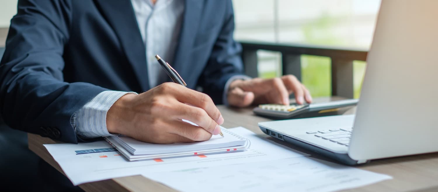 businesman signing a check